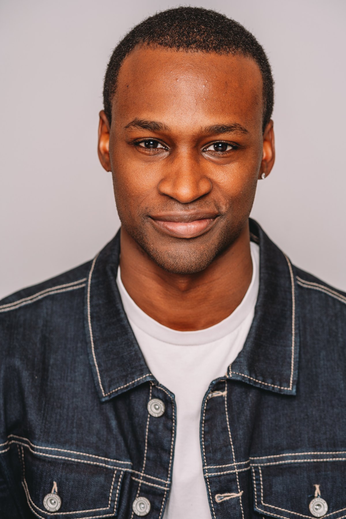Studio headshot in denim jacket